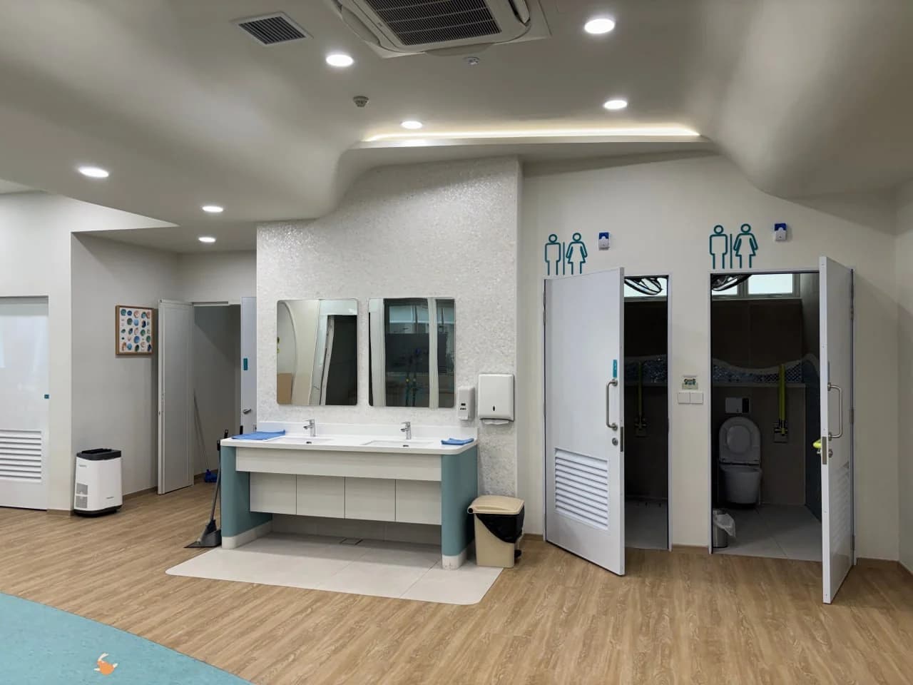 Accessible washroom lobby and shared vanity at NTUC Health Bedok