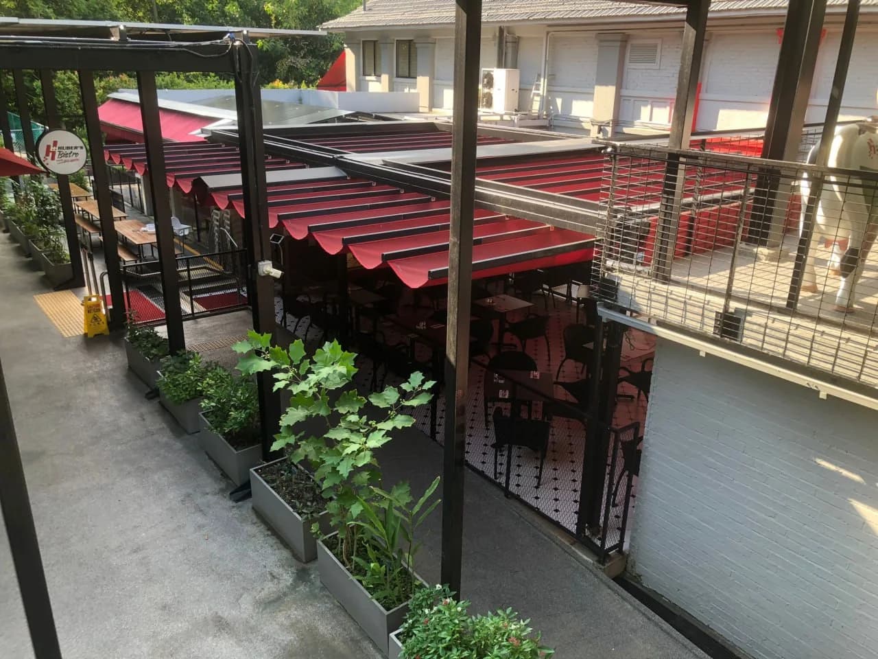 Huber’s Bistro outdoor dining area with red retractable canopies