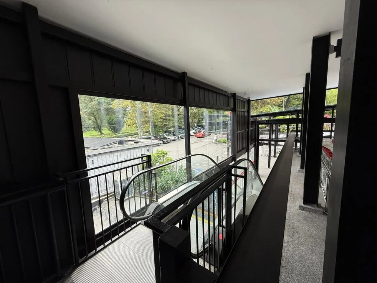 Upper-level gallery and escalator connection at Huber’s Butchery